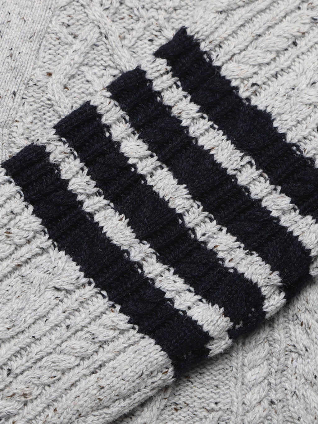 Cable knit cardigan by Thom Browne, knitwear detail view