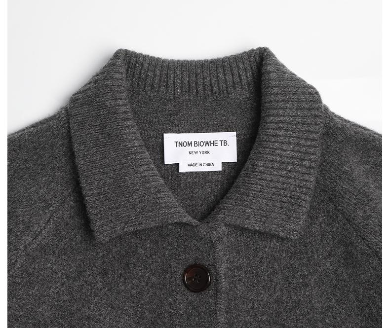 Unisex wool coat with webbing sleeves by Thom Browne, outerwear detail view