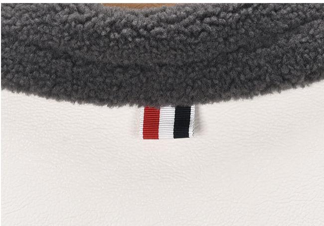 Lapel wool coat by Thom Browne, outerwear detail view