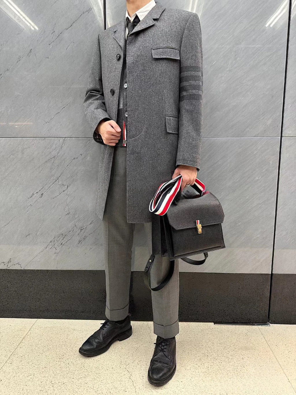 Unisex long wool coat by Thom Browne, outerwear detail view