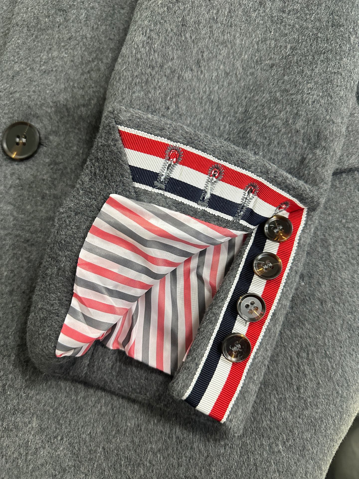 Unisex long wool coat by Thom Browne, outerwear detail view