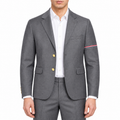 Men's suit jacket by Thom Browne, modeled on a pure white background