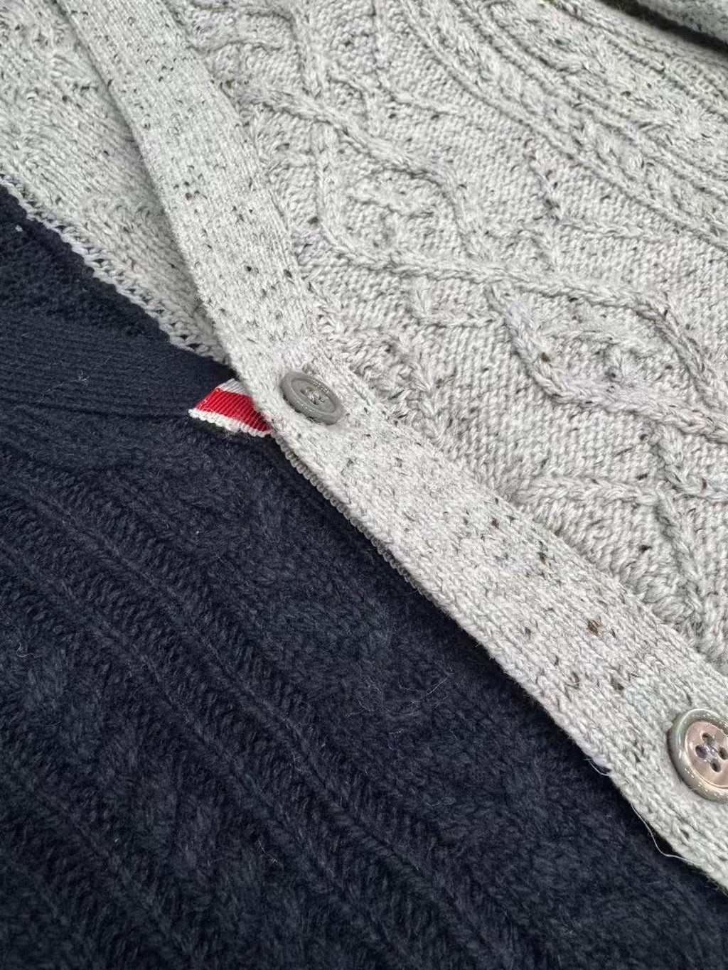 Cable knit cardigan by Thom Browne, knitwear detail view