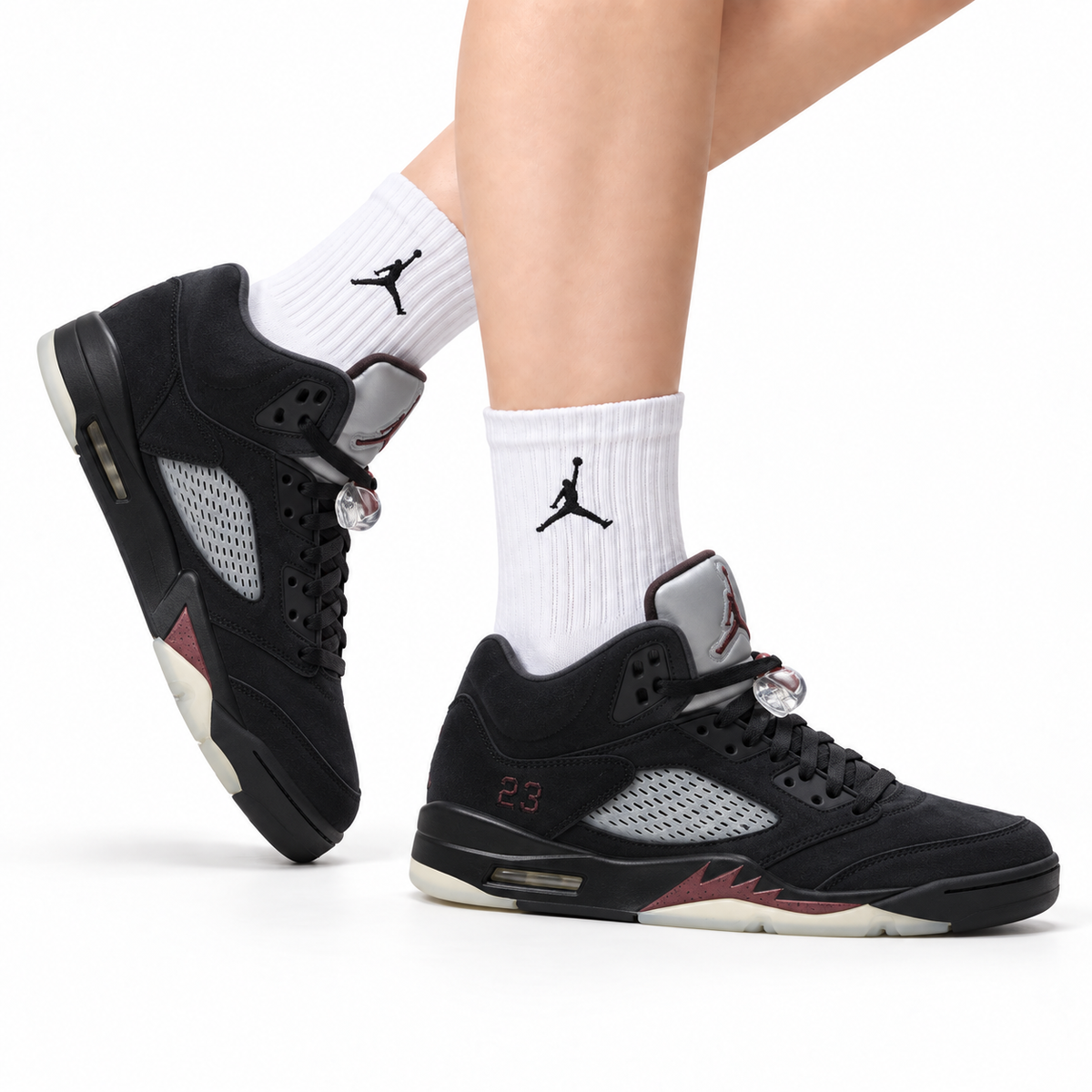 Air Jordan 5 Retro Triple Black Red Accent Sneakers on-foot product image on a pure white background