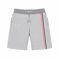 Gray striped knit shorts with drawstring and red navy side stripes on a white square background